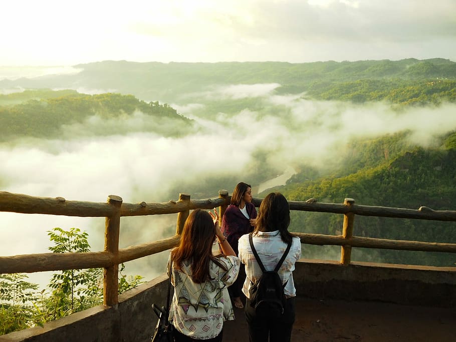 three woman standing on mountain cliff, three women standing near mountain HD wallpaper
