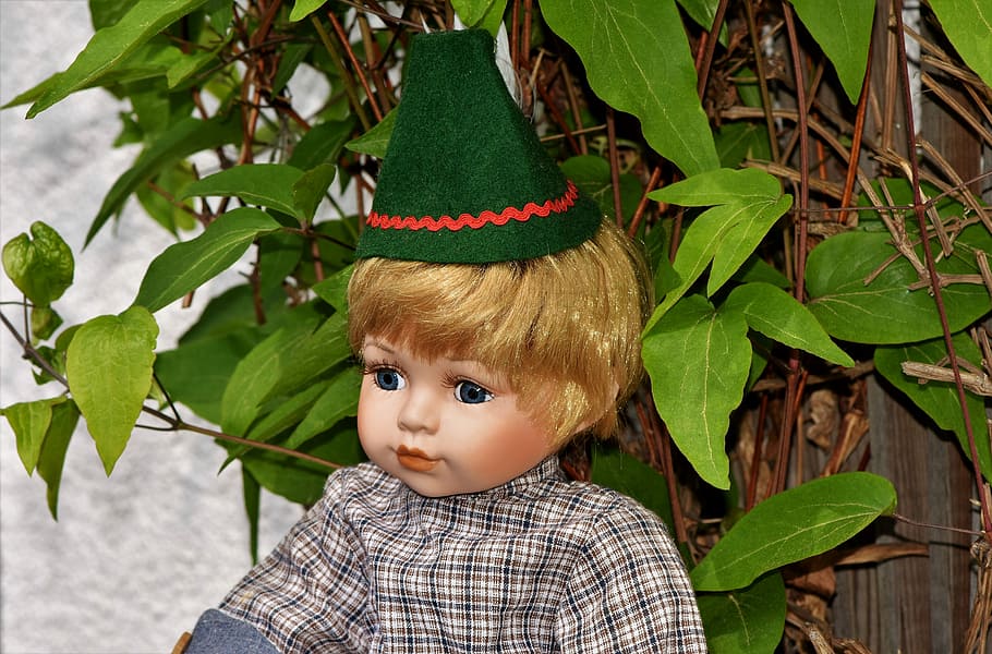 boy doll near green leaf plant, dolls head, cap, doll face HD wallpaper