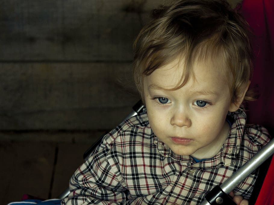 toddler boy sitting, kid, cute, baby, blue eyes, stroller, serious