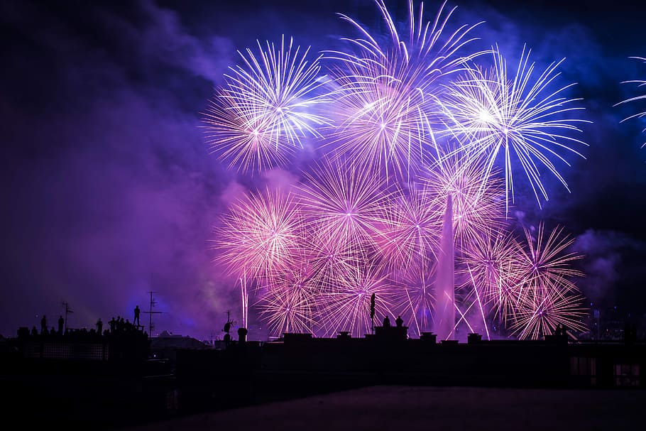 silhouette of buildings with purple and pink fireworks display, landscape photography of fireworks