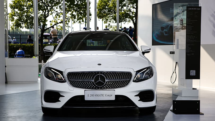 white Mercedes-Benz vehicle parked beside white painted wall HD wallpaper