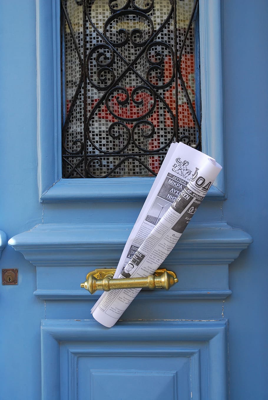 magazine paper on brass handle, newspaper, blue door, chios, design
