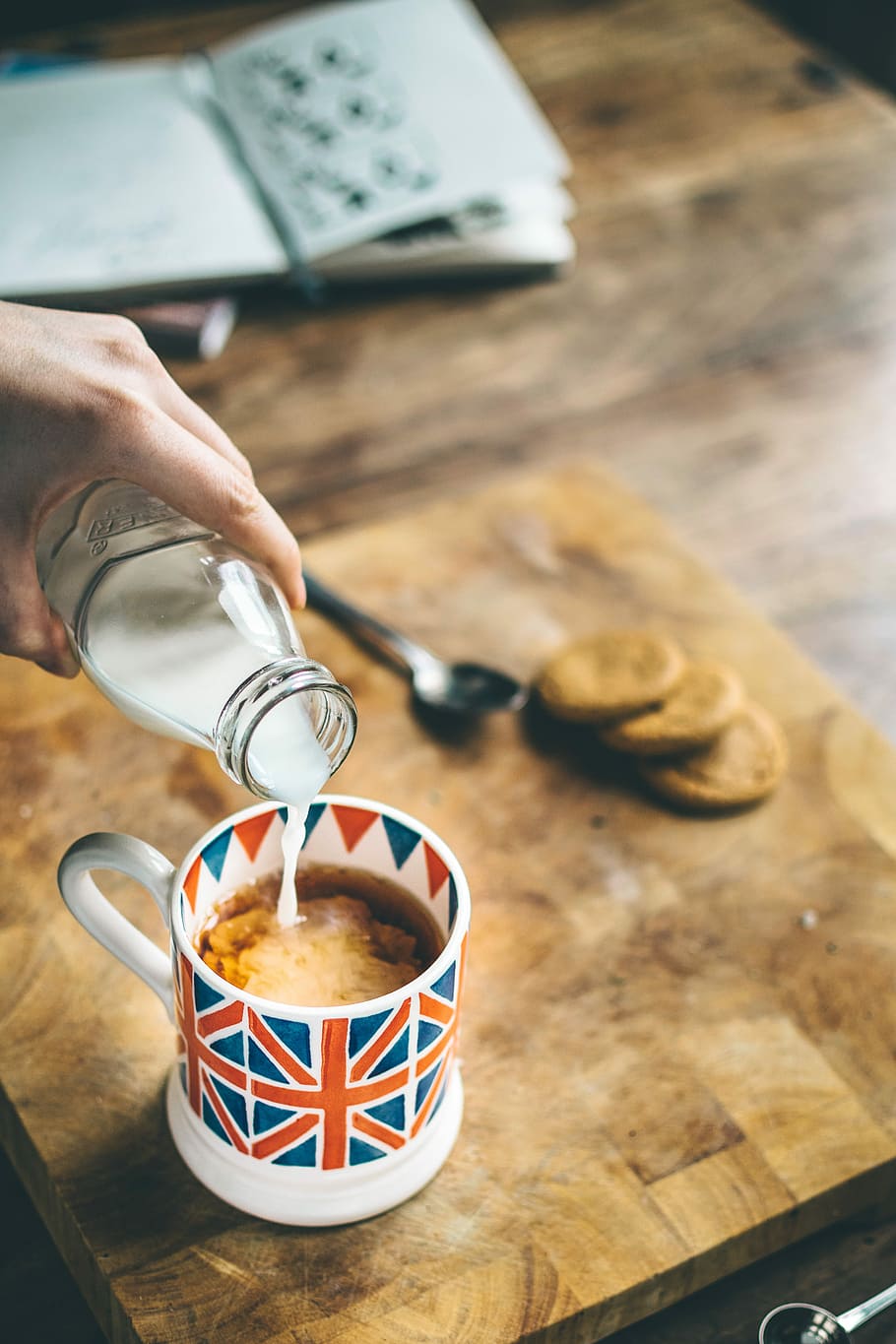 blue, red, and white mug filled with coffee, person pouring milk on coffee HD wallpaper