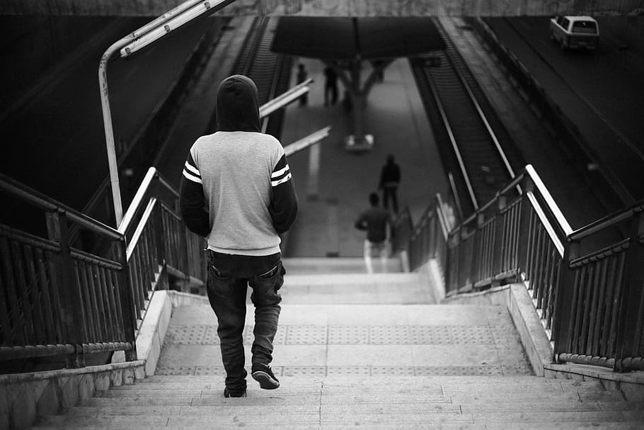 grayscale photo of person wearing hoodie walking on stairs, person walking down stairs HD wallpaper