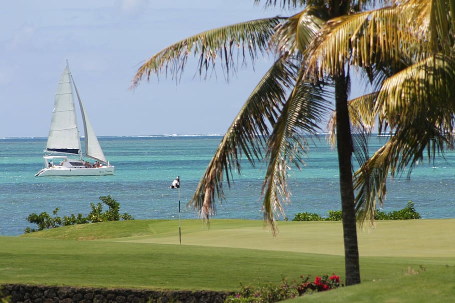 golf flag in front of sailboat on blue body of water, mauritius HD wallpaper