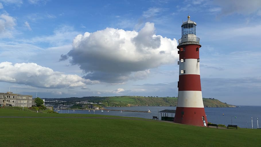 red and white striped lighthouse near body of water, sea, port