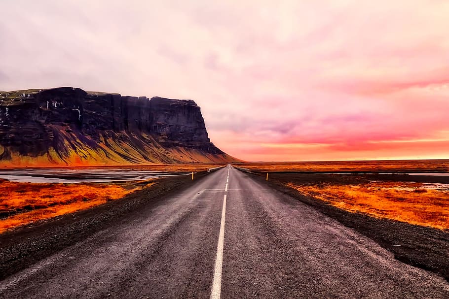 gray asphalt road near plateau under cloudy skies, iceland HD wallpaper