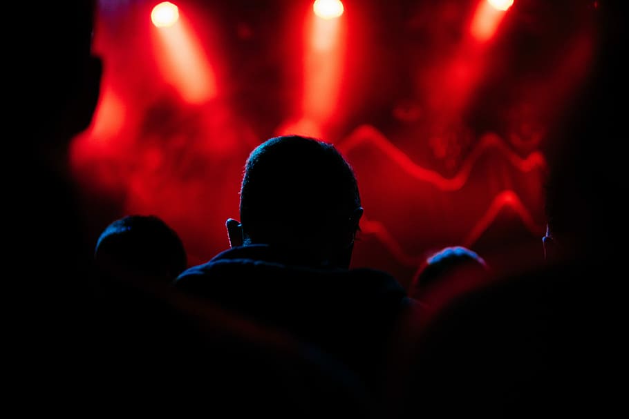 silhouette of a man in front of red lights, silhouette of people near stage HD wallpaper