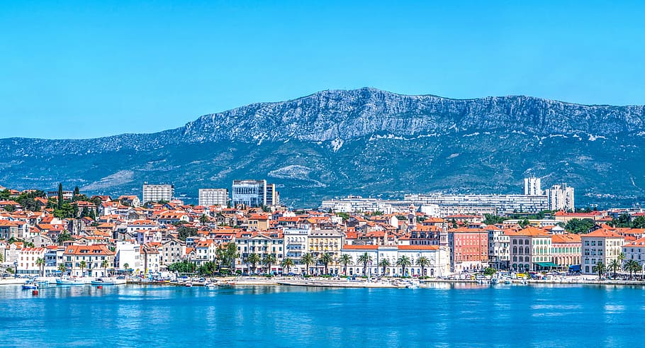 brown and white buildings near body of water and mountain, croatia HD wallpaper