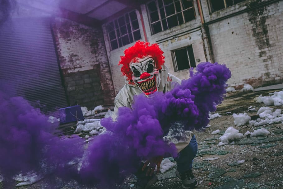 clown holding purple smoke bomb in ruined building, Killer Clown