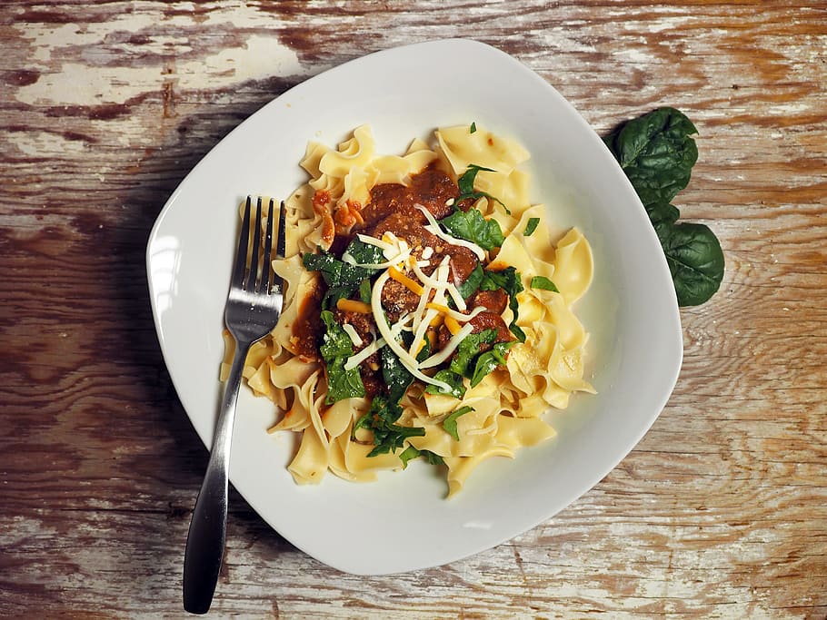 pasta dish with red sauce, sausage, cheese, fork, bowl, white HD wallpaper