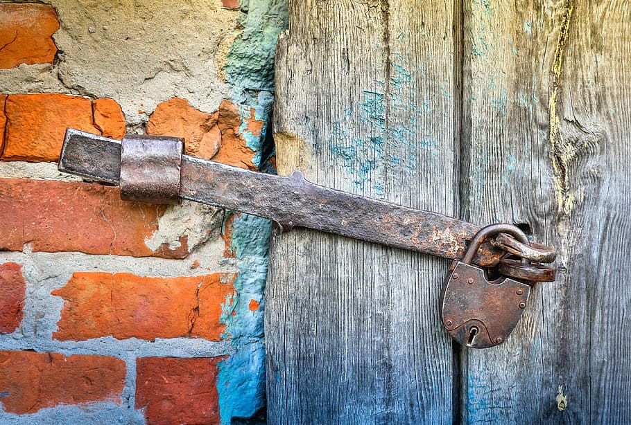brown metal door lock with padlock, hasp, castle, closed, old