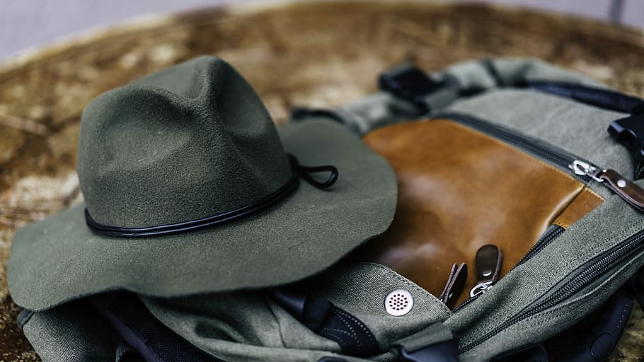 round hat on gray bag, black cowboy hat on black and brown bag HD wallpaper