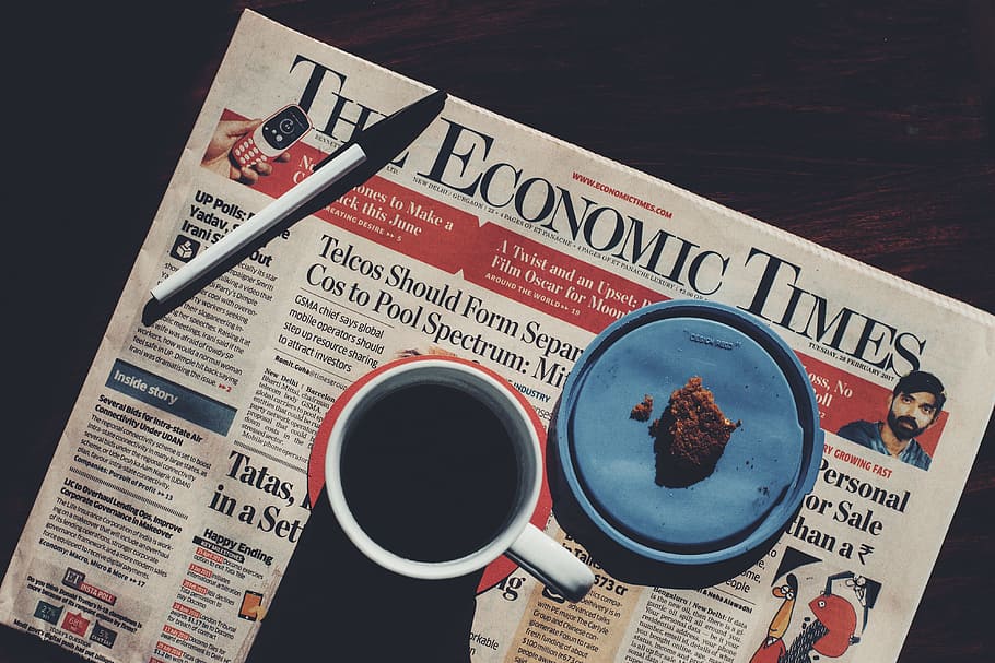 Coffee cup and newspaper on table, food/Drink, business, black background