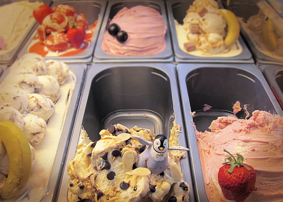 penguin figurine on ice cream, fridge, strawberry, chocolate