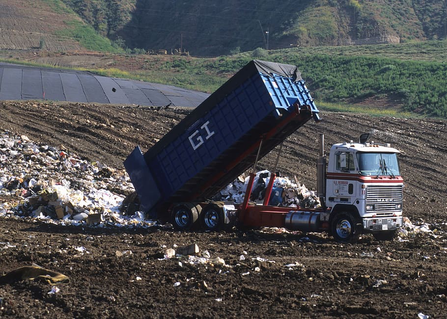 white and blue dump truck dumping garbage during daytime, Landfill