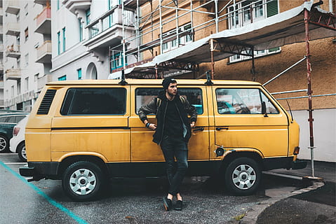 man leaning on yellow van, wearing, black, jacket, standing HD wallpaper