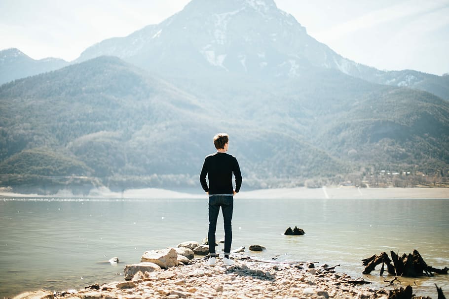 man standing on front of lake at daytime, man standing near body of water