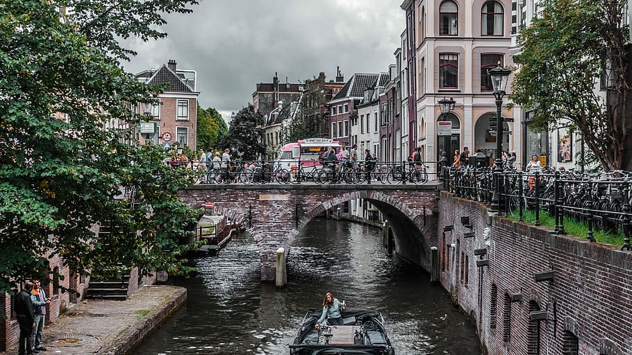 Amsterdam, woman on boat going under concrete bridge, structure HD wallpaper
