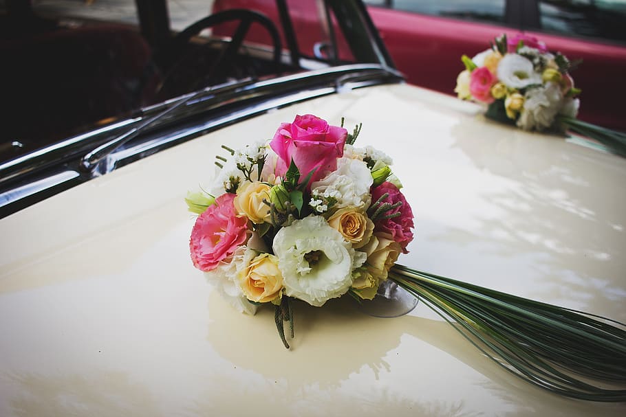selective focus photography of flower bouquet, bonnet, bridal car