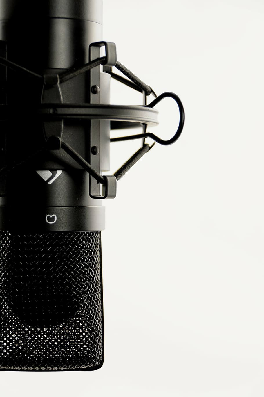 black condenser microphone against white background, studio, vocal microphone