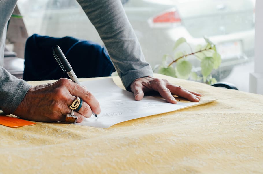 person writing on white plain paper on the table photography, man writing on white paper HD wallpaper