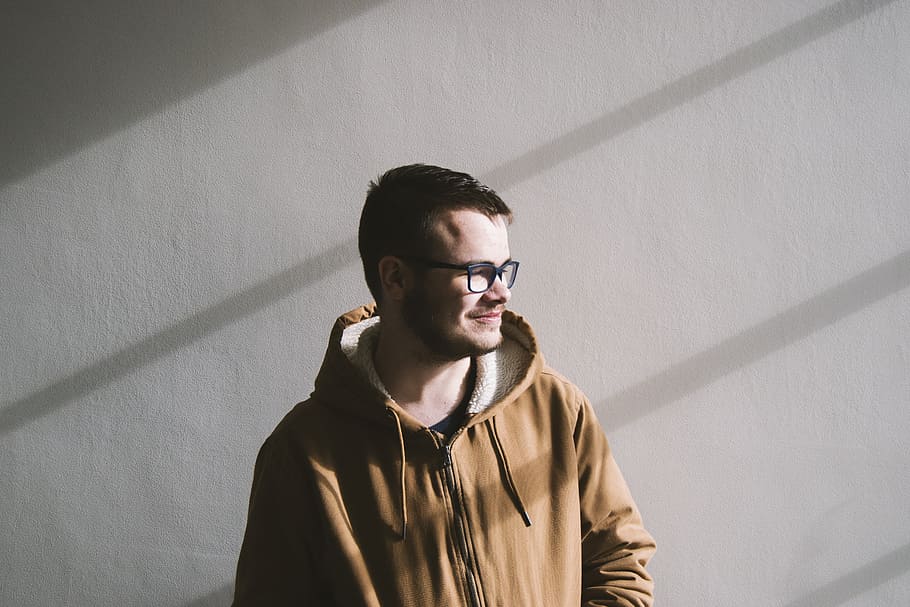 Colin, man standing near white wall, portrait, looking away, beard HD wallpaper