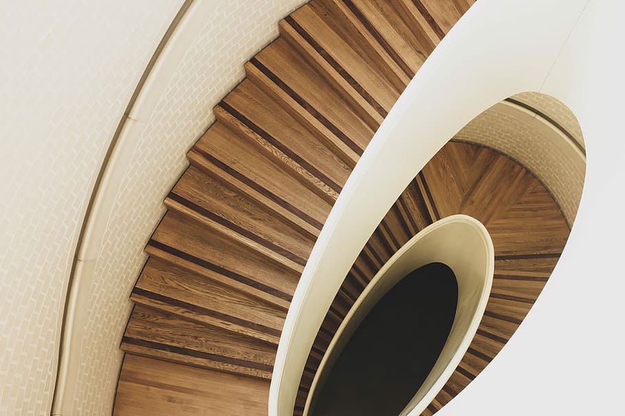 aerial photography of brown spiral stair way, aerial photography of brown wooden downstairs HD wallpaper
