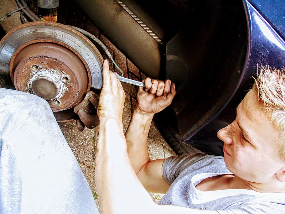 man repairing vehicle during daytime, car mechanic, disc brake, HD wallpaper