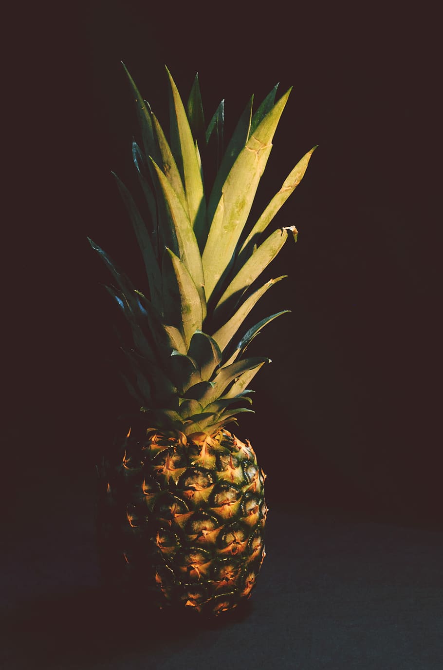 photo of pineapple fruit, pineapple, sunlight, shadow, black background