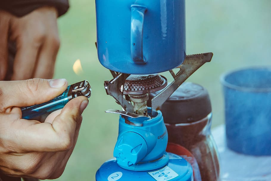 person lighting camping burner, hand, burning, flame, lighter HD wallpaper