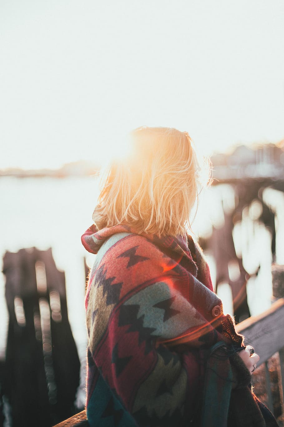 blonde haired woman with red, blue, and black jacket in tilt shift photography HD wallpaper