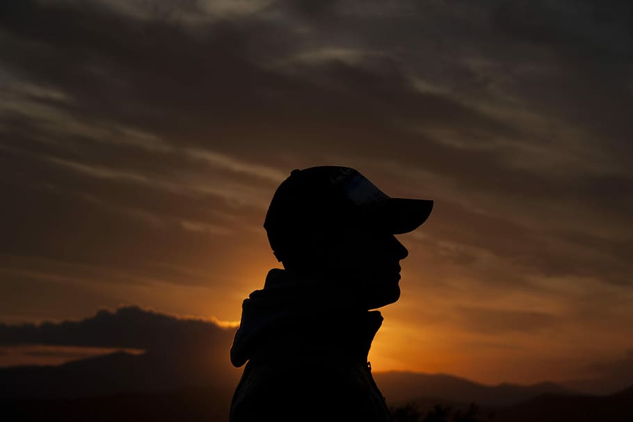 person's silhouette during golden hour, silhouette of person wearing cap looking right during golden hour HD wallpaper