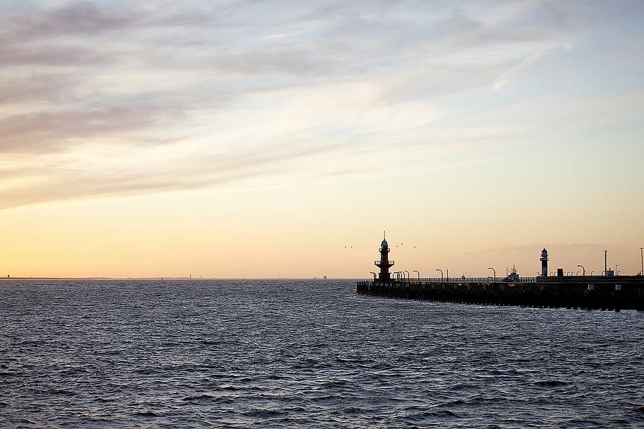 in distant photo of lighthouse during golden hour, low, sea HD wallpaper