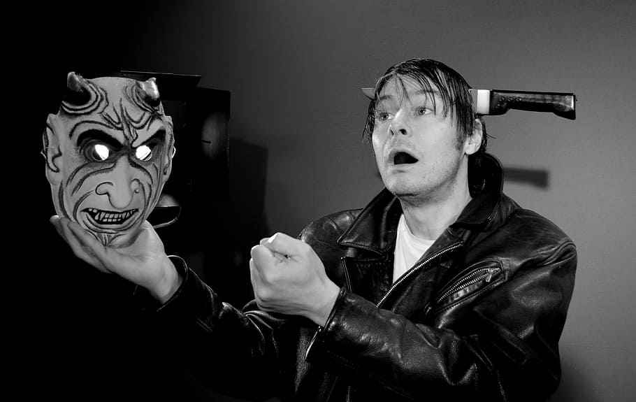 grayscale photo of man holding devil mask, shakespeare, hamlet