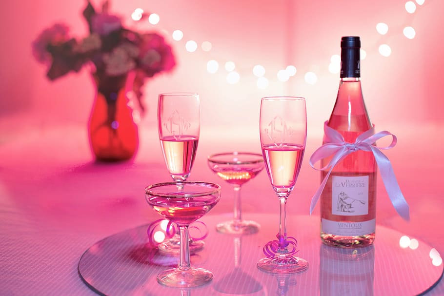 clear glass bottle and clear wine glasses, pink wine, champagne