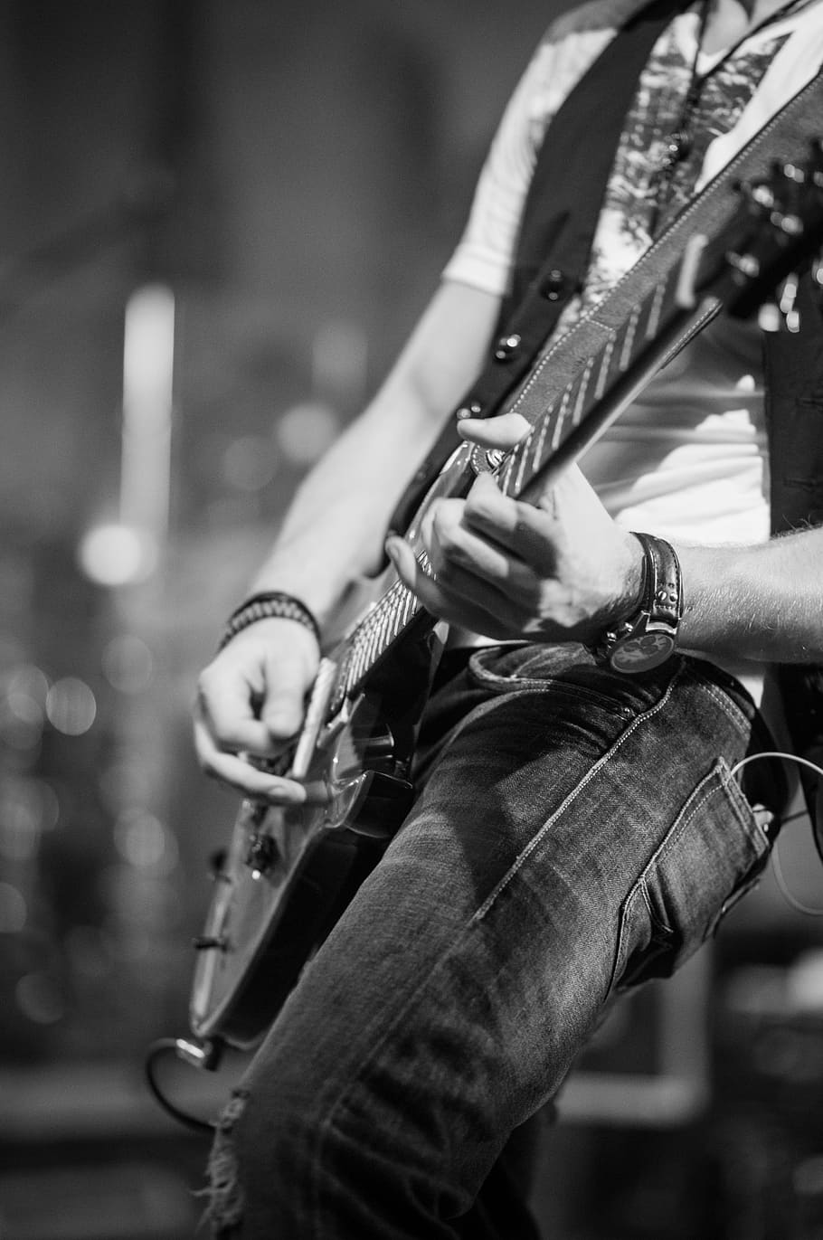 grayscale photo of person holding guitar, electric guitar, live