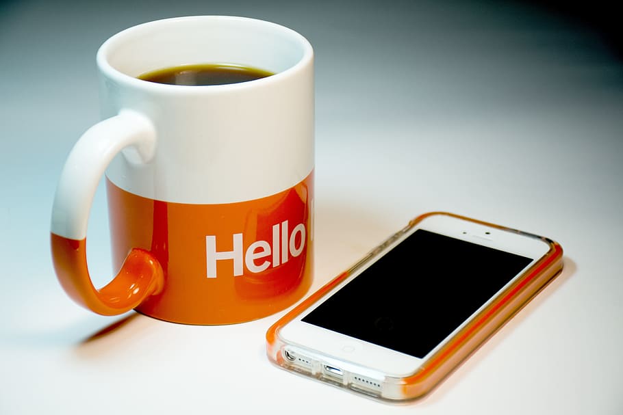 white iPhone 5 with orange case near white and orange hello ceramic coffee mug, HD wallpaper