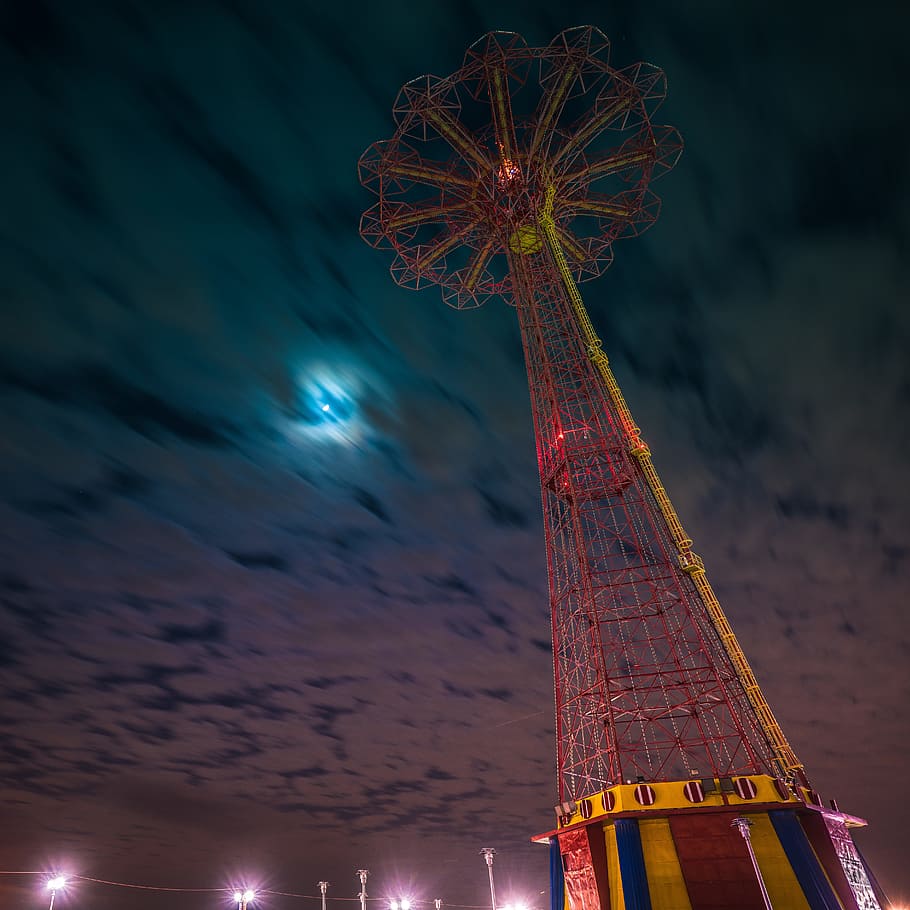 worm's eye view of red and yellow tower, red and yellow amusement park ride under cloudy night sky HD wallpaper