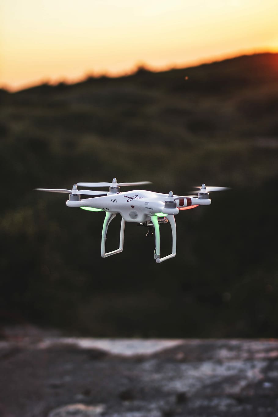 flying quadcopter drone during sunset, white and red quadcopter drone on mid air HD wallpaper