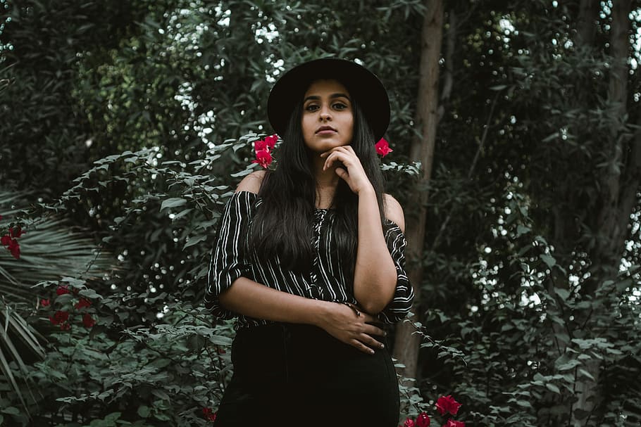 woman in black and white striped off-shoulder shirt, woman standing under trees taken at daytime HD wallpaper