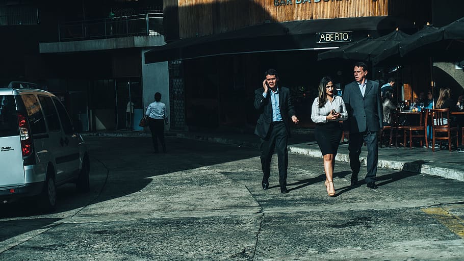 Woman in White Dress Shirt Between Men in Suit Standing on Concrete Ground HD wallpaper