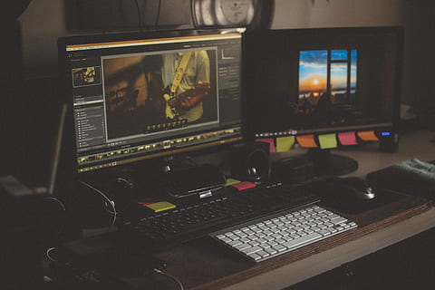 turned on two computer monitors beside two black and white keyboards on desk, two computer sets on desk HD wallpaper