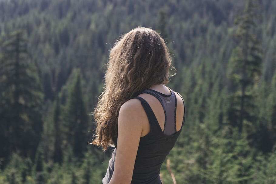 woman standing while watching green trees at daytime, woman facing woods during daytime