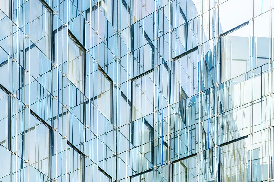 architectural photography of glass building, reflection of building on glass windows