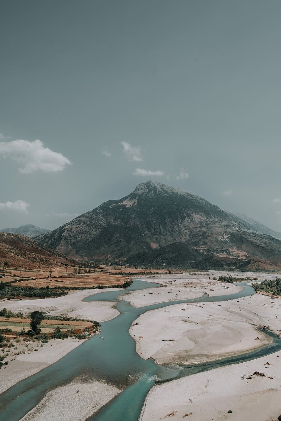 river near mountain at daytime, body of water under sunny sky HD wallpaper