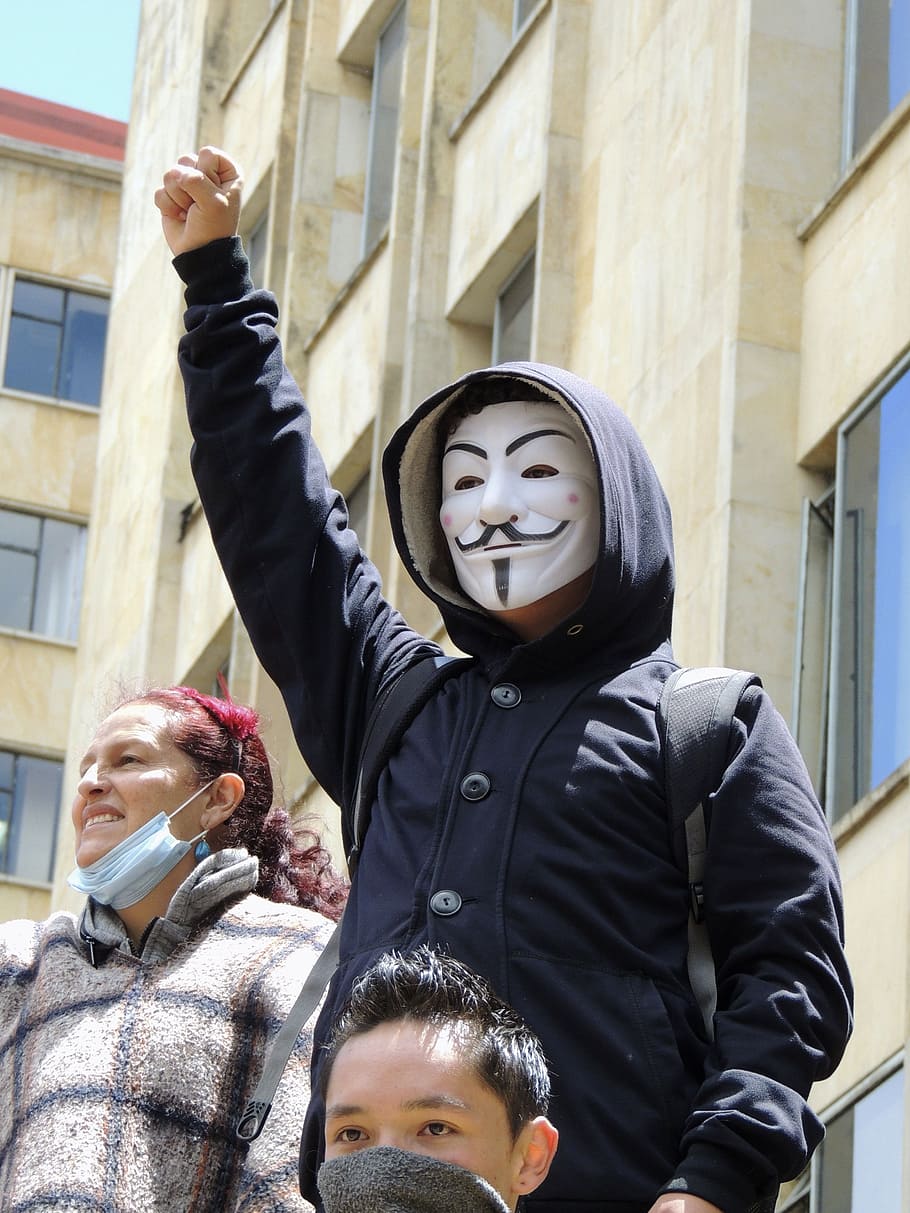 person wearing blue button-up hooded jacket and guy fawkes mask HD wallpaper