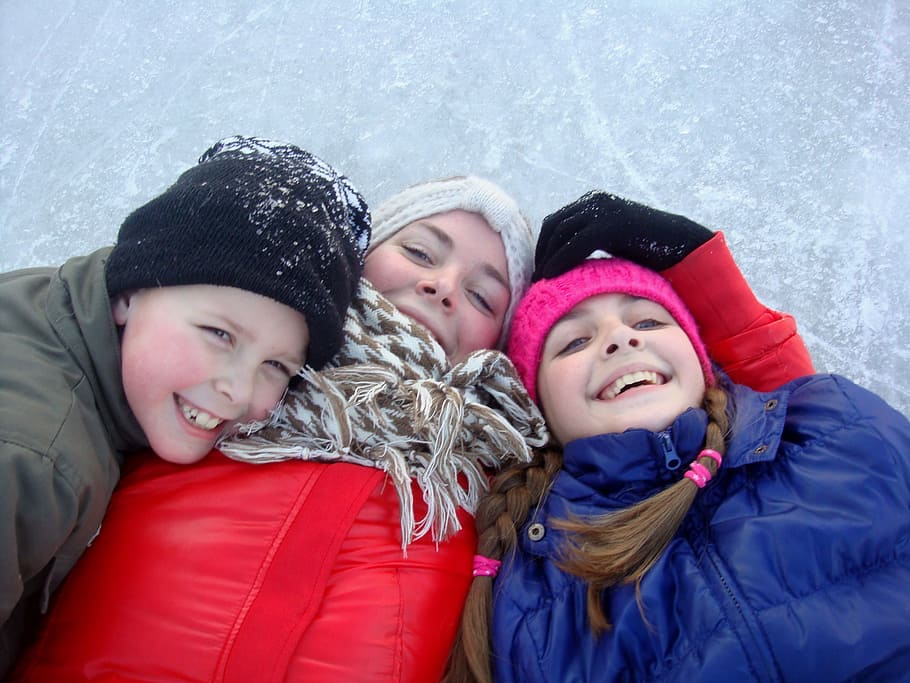 three children lying on snow, ice skating, fun, are, hat, together HD wallpaper