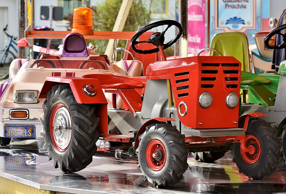 red ride-on tractor on table, carousel, auto, children car, carousel auto