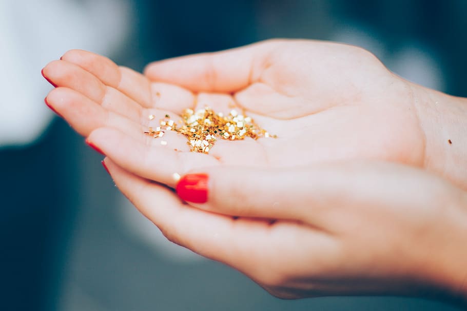 gold glitters on person's hand, hands, macro, shiny, human hand HD wallpaper